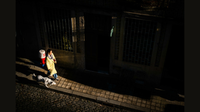 Woman with dog walking in Porto