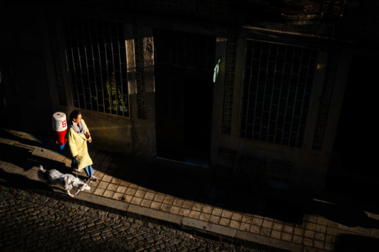 Woman with dog walking in Porto