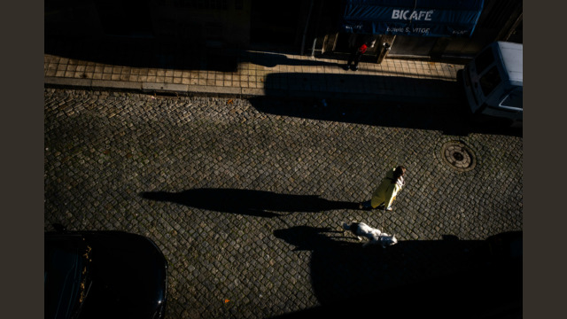 Woman with dog walking in Porto
